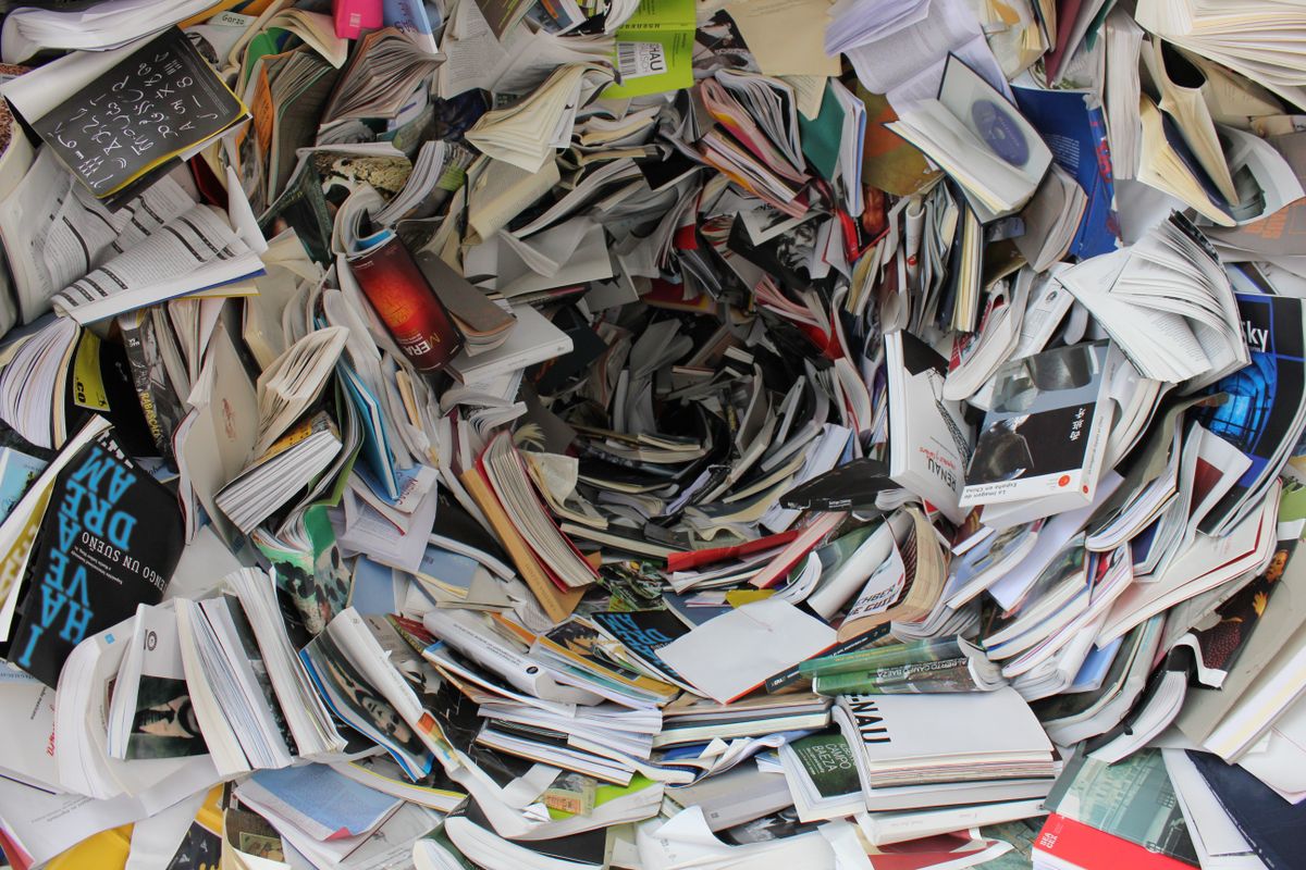 Paper stock samples arranged on a dark studio table