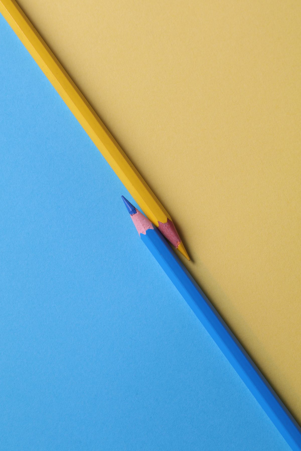 Paper colour samples fanned on a dark studio table beside marked proofs